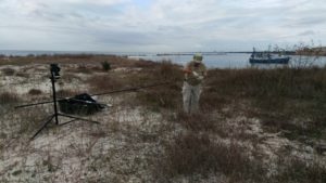 NA5DX assembles the antenna as a shrimp boat rests in protected water north of the island: